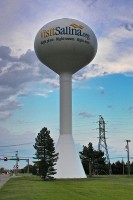 A water tower in Salina, bearing the Chamber of Commerce's URL and slogan.